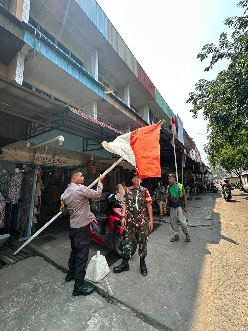 Bhabinkamtibmas Siantan Tengah Bersama Tiga Pilar Ajak Warga Memasang Bendera Merah Putih Jelang Hut RI Ke-81