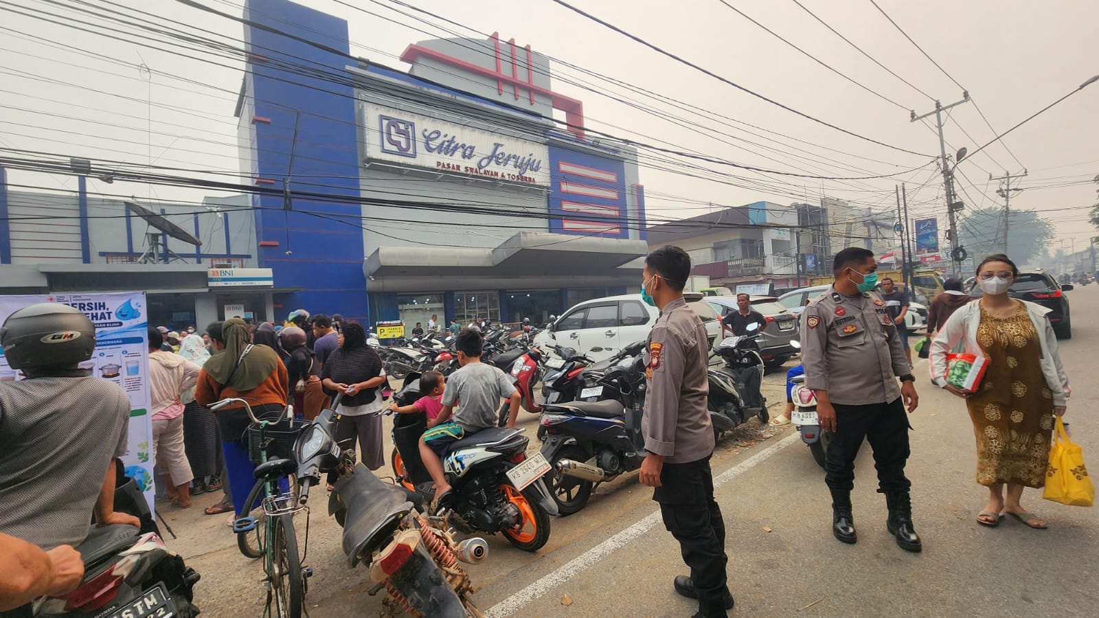 Pelayanan kepada Masyarakat, Polsek Pontianak Barat Amankan Pendistribusian Air Minum Bersih Gratis PMI Kalbar.